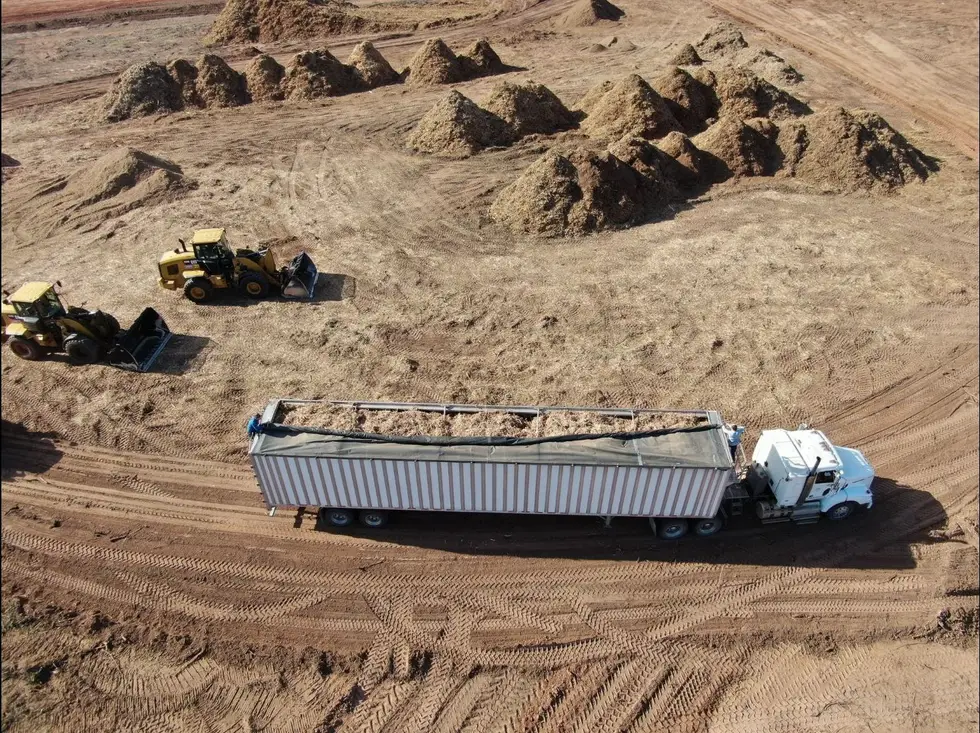 Aerial view of a semi trailer and wheel loaders working mulch piles for haul off in Oklahoma