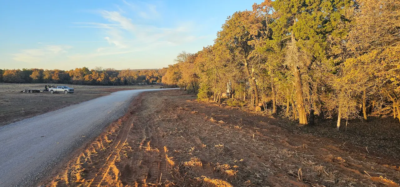 ROW clearing along a rural Oklahoma road, right of way cleared and mulched back to the fence line